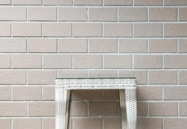 Closeup wood weave table on blurred brown brick wall texture background , beautiful interior in relaxation of house concept