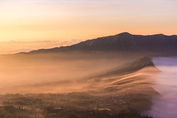 Cemoro Lawang; small village in morning mist. Which situated on the edge of massive north-east of Mount Bromo, East Java, Indonesia