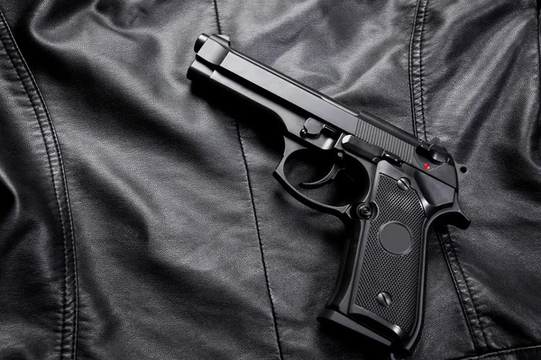 Gun on leather jacket