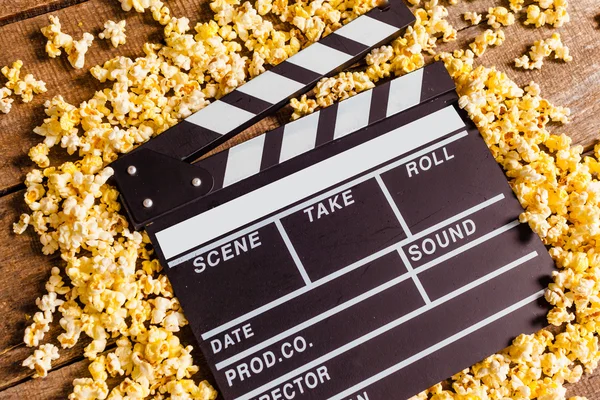 Movie clapperboard and popcorn