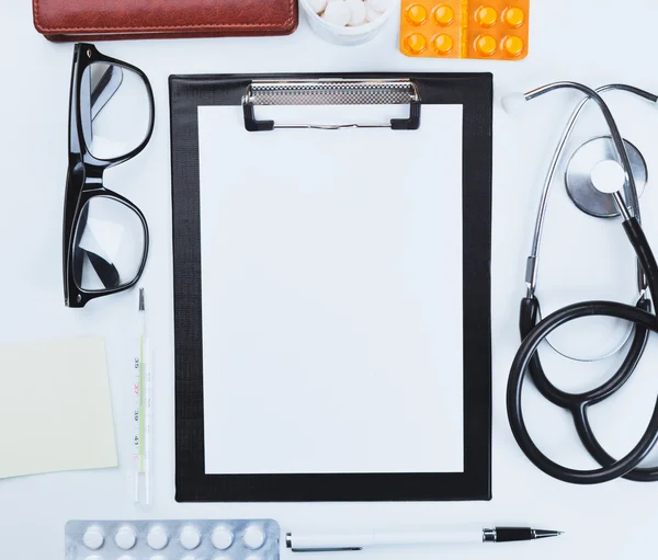 Medical clipboard and stethoscope. Top view.