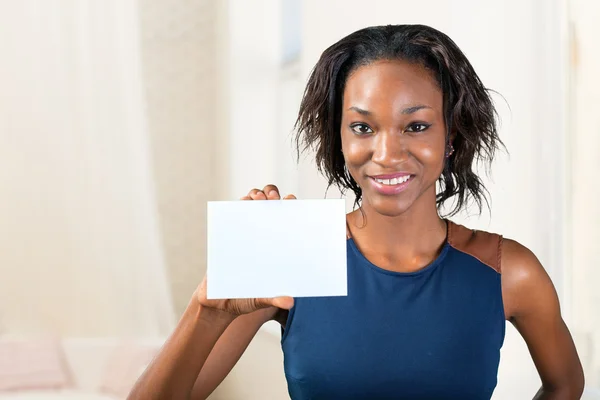Woman with a perfect smile holds a business card