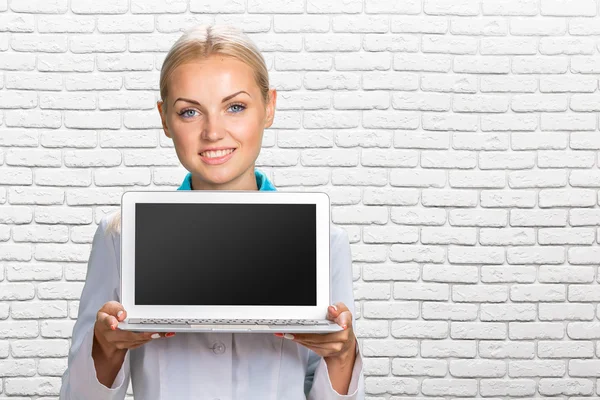 Woman doctor holding a laptop computer