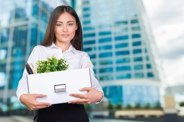 Business woman with a box to move to a new office.