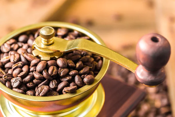 Cup of steaming hot coffee with coffee beans, coffee grinder, and coffee beans bag