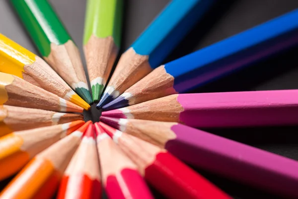 Color pencils in arrange in color wheel. Assortment of colored pencils.