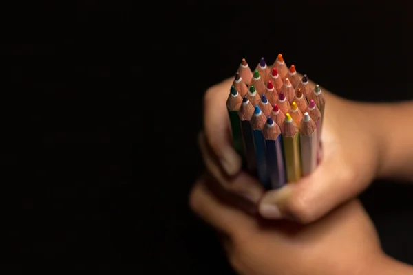 Child\'s hands with pencils, back to school.  Child\'s hands with lots of colorful pencils.