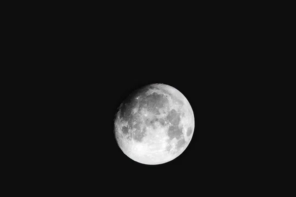 Nearly full Moon. The Earth's only natural satellite on black night sky.