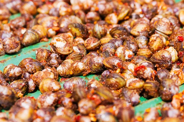 Lee hal - small river shells, mixed with chili, salt, sugar, flavor enhancer and sun-dried. Traditional snack in Cambodia. Asian exotic food.