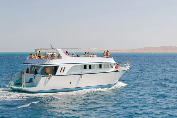 HURGADA, EGYPT - September 11, 2008. Tourists sailing on a yacht in the Red sea. Boat trip on bright sunny day.