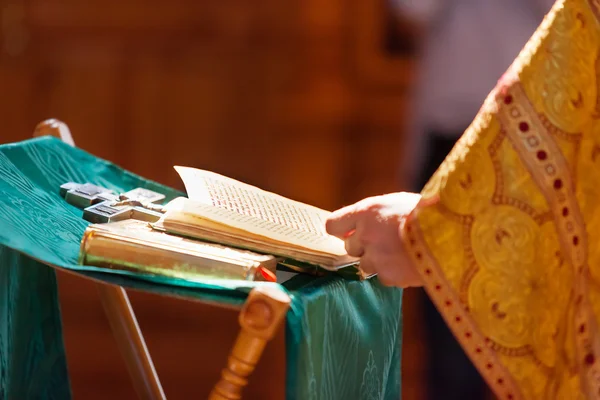 Prayer book in the hands of the priest. Ceremony in the Orthodox Christian Church. Russia. Selective focus.