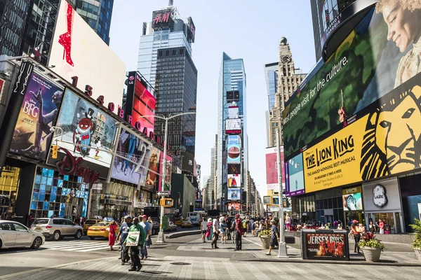 New York, USA - June 18, 2016: Times Square during the day with advertisements for the Lion King musical and stores such as Forever 21 and H&M