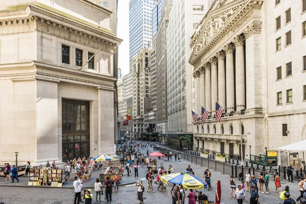 New York, USA - June 18, 2016: Wall street and the New York Stock exchange in New York City with hot dog stands