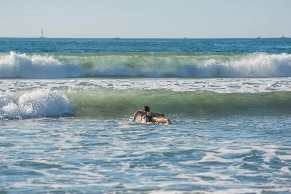 Male surfer getting ready for upcoming wave