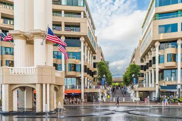 Georgetown outdoor mall with restaurants and large fountain on Potomac riverfront with people walking