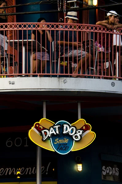 Dat Dog restaurant with people eating at the background.