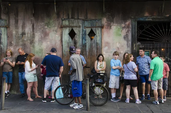 Line of people of standing in line for a music performance on Bourbon Street in New Orleans