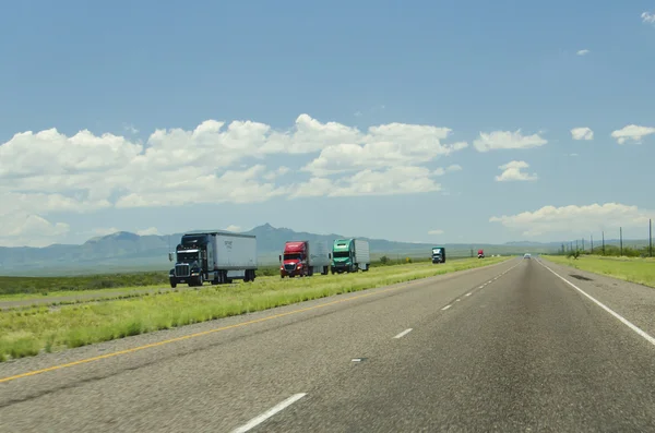 Multiple Truck Trailers Driving on Highway in New Mexico