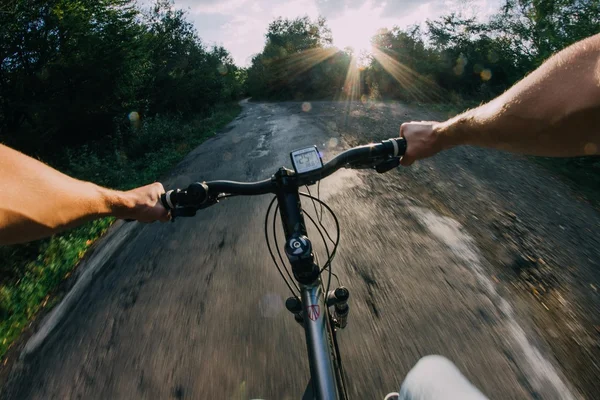 Human hands on bike riding on road