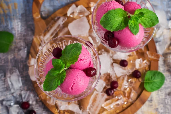 Cherry ice cream in a glass ice-cream bowls, top view, selective