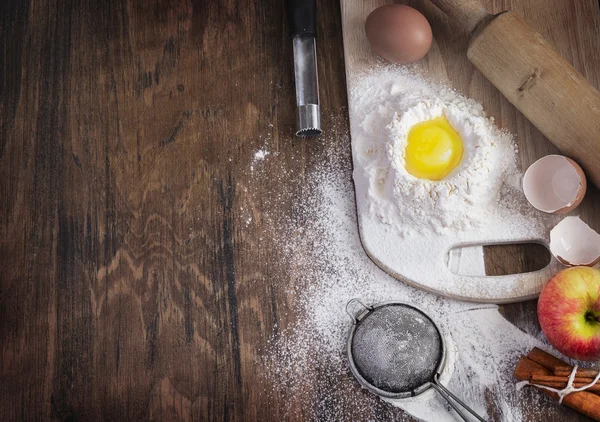 Baking background with raw egg, flour and apple, empty template