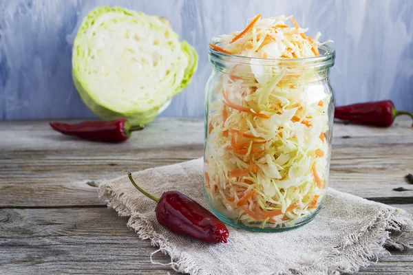 Pickled cabbage with carrots and red hot peppers