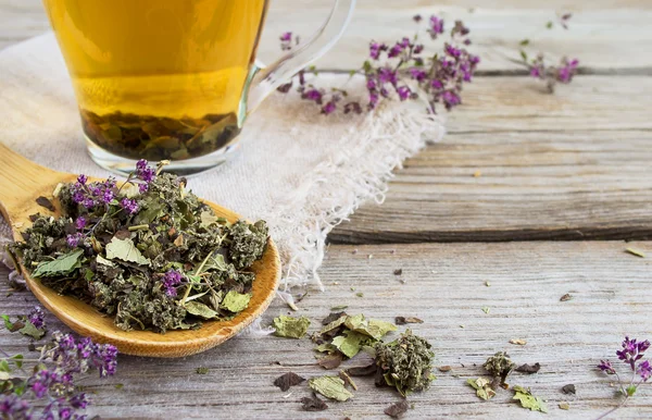 Dry herb tea on a background of cups with tea