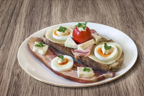 Bacon Cheese Egg Ham and Tomato Sandwich on Wooden Background