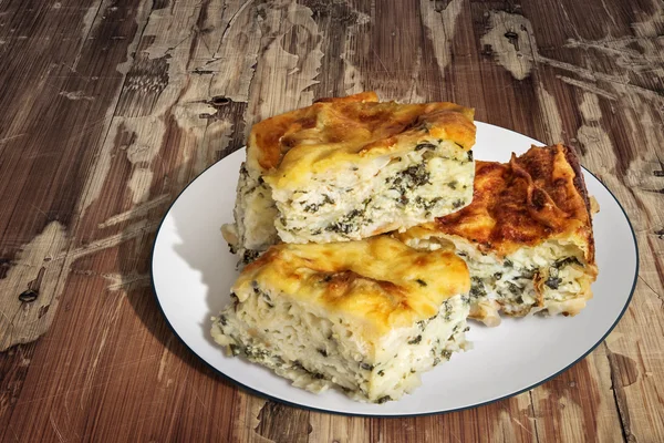 Plate of Serbian Cheese Spinach Pie Zeljanica Slices on Old Wooden Table Surface