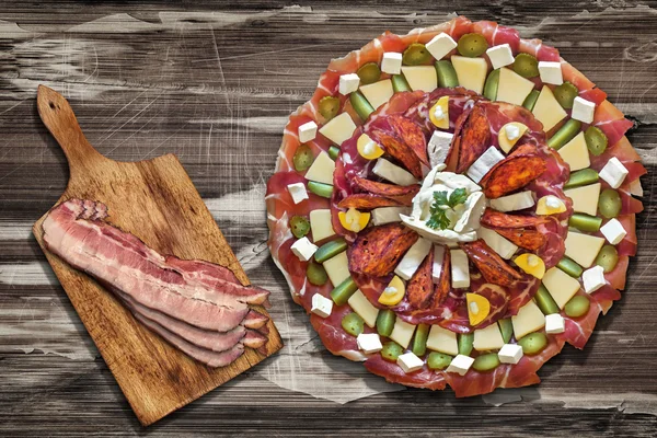 Appetizer Savory Dish Meze with Bacon Rashers on Old Wood Background