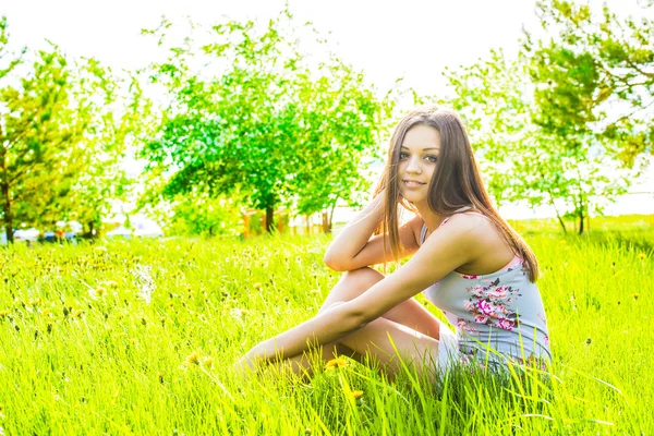 Woman sitting in meadow
