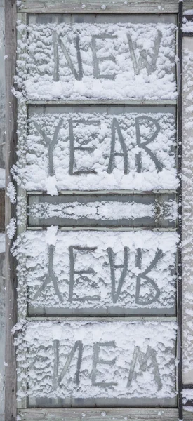 New Year text  on frozen window