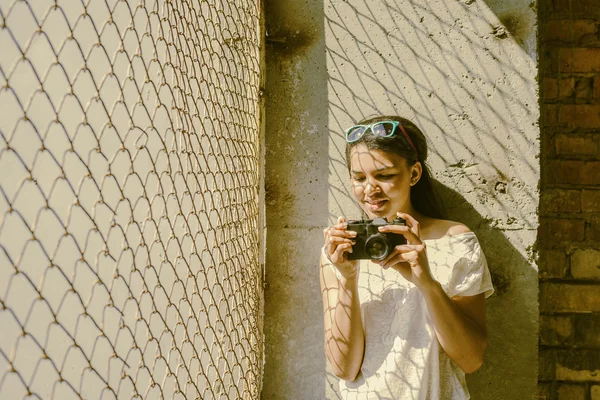 Woman holding  vintage camera