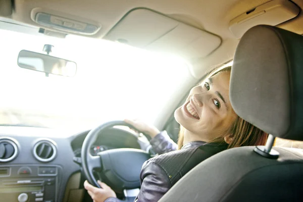 Young woman in car  turning