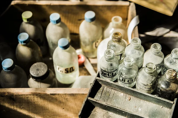 Old pharmacy bottles covered with dust