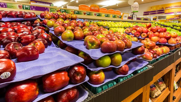 Shelf with apples in an American supermarket.