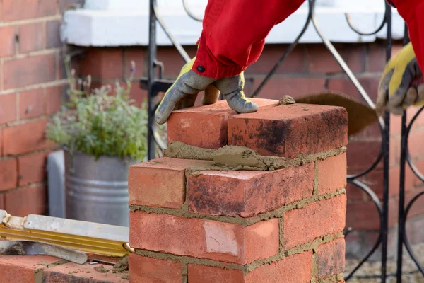 Bricklayer laying brick