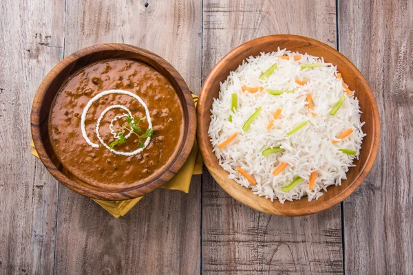 Dal Makhani or daal makhni or Daal makhani, indian lunch/dinner item served with plain rice and butter Roti, Chapati, Paratha and salad, over blue wooden table top