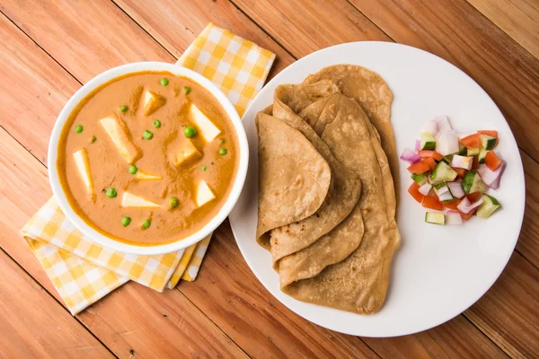 Indian food paneer butter masala served with chapati / roti / paratha / fulka / indian bread with green salad