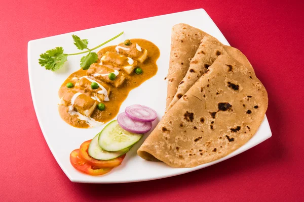 Indian food paneer butter masala served with chapati / roti / paratha / fulka / indian bread with green salad