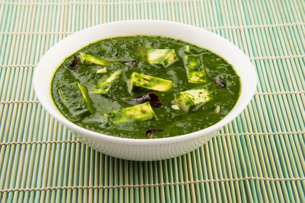 Palak Paneer , Indian food Spinach and Indian cottage cheese curry - Side dish for Rice and roti / chapati / indian bread / phulka / paratha , isolated