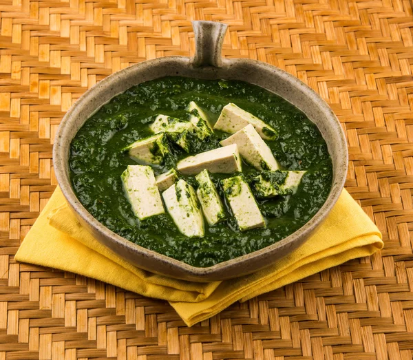 Palak Paneer , Indian food Spinach and Indian cottage cheese curry - Side dish for Rice and roti / chapati / indian bread / phulka / paratha , isolated
