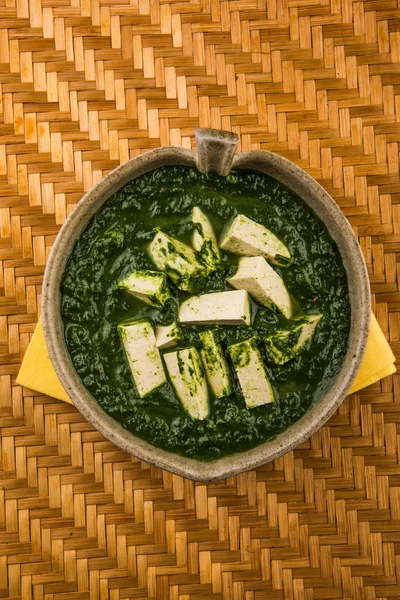 Palak Paneer , Indian food Spinach and Indian cottage cheese curry - Side dish for Rice and roti / chapati / indian bread / phulka / paratha , isolated