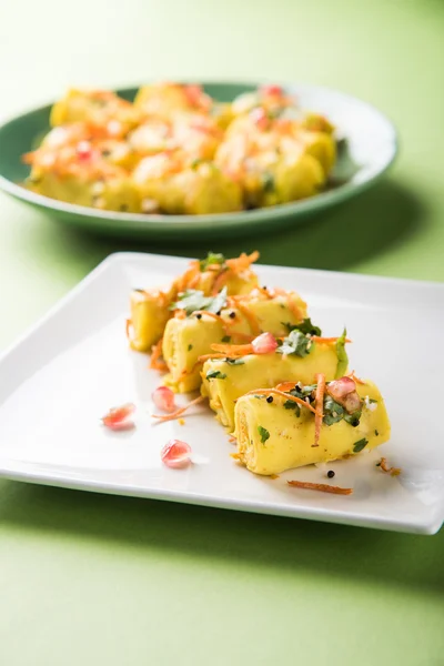Khandvi is a gujarati snack from India which is made with gram flour and curds tempered with sesame seeds and mustard seeds also known as Surali chya Vadya/Stuffed Khandvi, selective focus