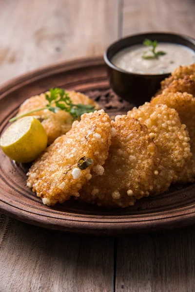 Tasty sabudana vada or sabudana vade made up of Sago served with peanut chutney, a famous fasting recipe or snack from maharashtra, India