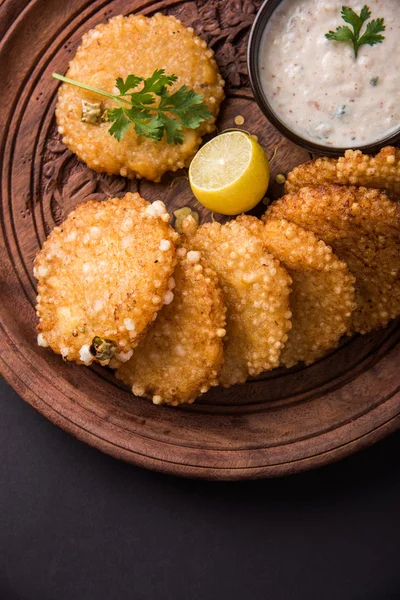 Tasty sabudana vada or sabudana vade made up of Sago served with peanut chutney, a famous fasting recipe or snack from maharashtra, India