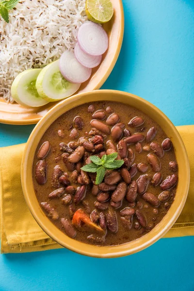 Cooked red kidney beans curry and cooked basmati rice, rajma chawal or rajma rice, traditional north indian lunch, dinner or breakfast menu