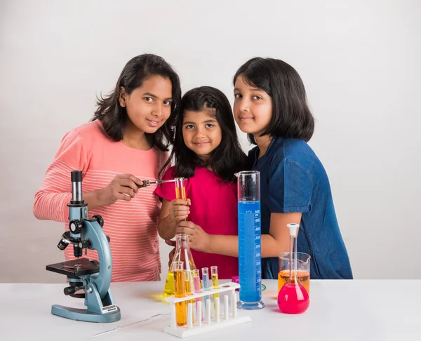 Indian little girls or indian students and science experiments. Education. asian kids and science experiments, chemistry experiment, indian girls and science experiments