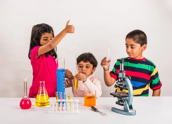 3 indian kids doing science experiment, science Education. asian kids and science experiments, chemistry experiment, indian kids and science experiments, indian kids and science lab