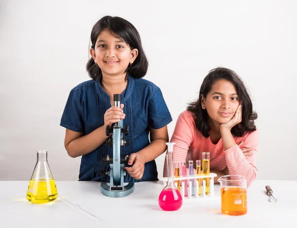 Indian little girls or indian students and science experiments. Education. asian kids and science experiments, chemistry experiment, indian girls and science experiments